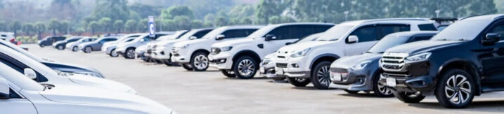Line of used cars and trucks on a car dealer's lot