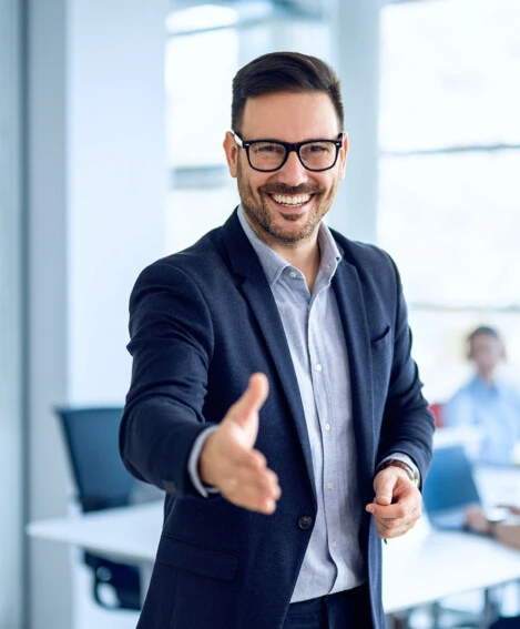 Car Dealer smiling and ready to shake your hand